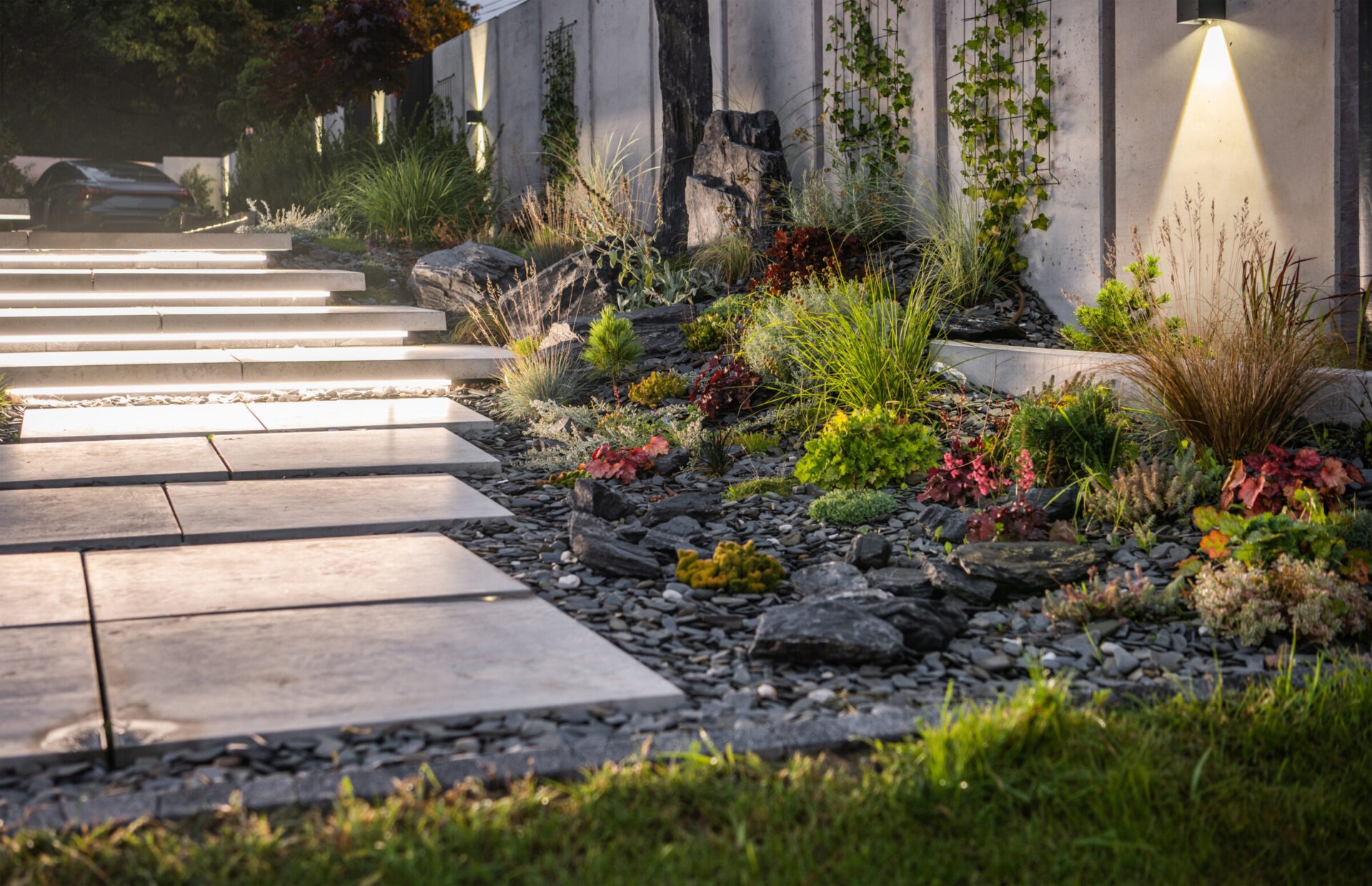 Illuminated Residential Backyard Garden by LED Lights. Modern Architectural Concrete Wall and Stairs Elements Design